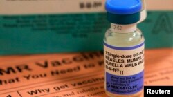 FILE - A vial of measles, mumps and rubella vaccine and an information sheet is seen at Boston Children's Hospital in Boston, Feb. 26, 2015.