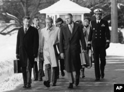 FILE - President Jimmy Carter, flanked by Secretary of State Cyrus (right) and his adviser on foreign policy, Zbigniew Brzezinski (left), walk toward a waiting helicopter to fly to the nearby Andrews Air Force Base, Md.