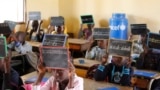 Second-graders in Alieu Samb primary school hold up chalk boards with French conjugations. Dakar, Senegal, Dec. 7 2017. (Photo: Sofia Christensen for VOA) 