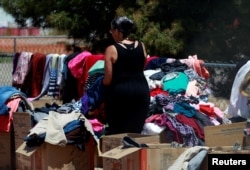 A volunteer sorts clothes donated for Central American migrants who are being accommodated at a temporary shelter after illegally crossing the border between Mexico and the U.S., in Deming, New Mexico, May 16, 2019.