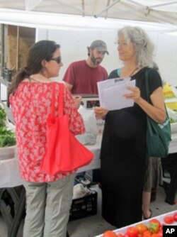 Irene Zola passes out fliers, hoping to interest neighborhood residents in becoming Morningside Village volunteers.