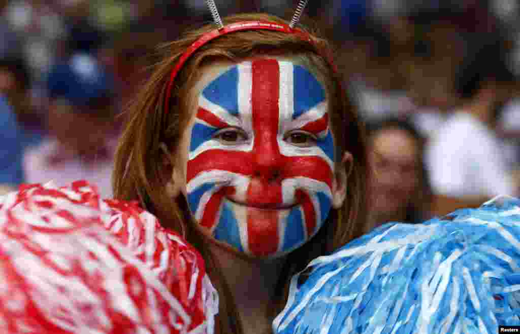 A Britain fan, with her face painted in the style of the Union Jack, smiles while attending the men's Group A football match against Senegal at the London 2012 Olympic Games in Old Trafford, Manchester, northern England July 26, 2012. 