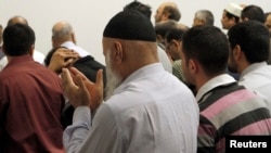 FILE - Members of the Chicago's Muslim community take part in afternoon prayer at the Downtown Islamic Center in Chicago, March 10, 2011. A national survey shows workplace religious discrimination is rising across the U.S.