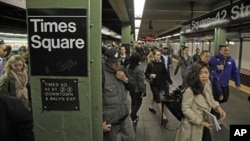In this 2012 file photo, passengers exit a subway train at New York's Times Square station.