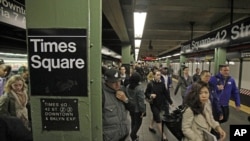 Passengers exit a subway train at New York's Times Square station, Nov. 1, 2012. 