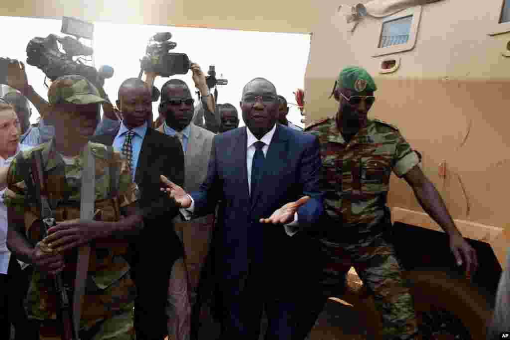 Michel Djotodia, Central African Republic's president, walks back to the Chadian armored vehicle he arrived in following his meeting with U.S. Ambassador to the United Nations Samantha Power, at the airport in Bangui, Central African Republic, Dec. 19, 2013.