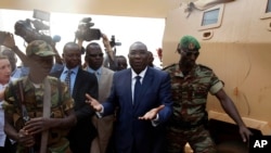 Michel Djotodia, Central African Republic's president, walks back to the Chadian armored vehicle he arrived in following his meeting with US Ambassador to the United Nations Samantha Power at the airport in Bangui, Central African Republic, Thursday Dec. 