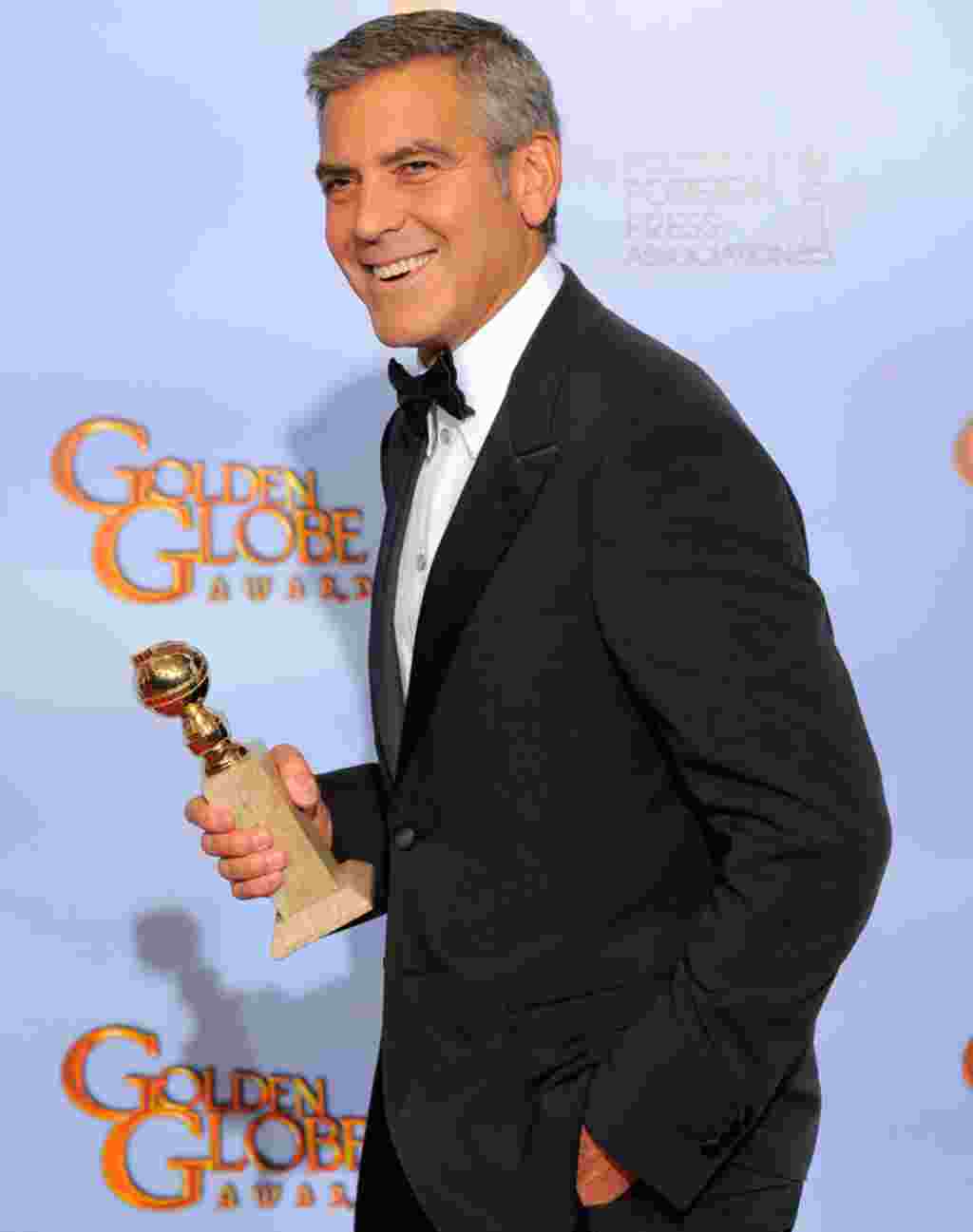 Actor George Clooney poses backstage with the award for Best Actor in a Motion Picture Drama for the film "The Descendants" during the 69th Annual Golden Globe Awards on January 15, 2012, in Los Angeles. (AP)