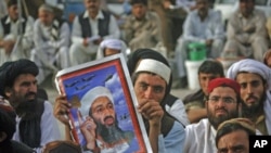 Supporters of Pakistani religious party Jamiat-e-Ulema-e-Islam hold an image of al-Qaida leader Osama bin Laden during an anti-American rally in Quetta, Pakistan, May 2, 2012.