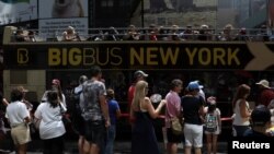 Para turis antre untuk menaiki bus wisata kota New York yang sangat populer sebelum datangnya pandemi (foto: dok). 
