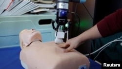 This photo shows a robot designed to help medical workers treat coronavirus patients remotely is pictured during a demonstration for the media at the aerospace engineering school of Tsinghua University in Beijing, China March 4, 2020. (REUTERS/Carlos Garc