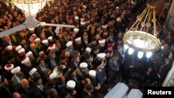 People and officials attend funeral prayers for a senior pro-Syrian government Muslim cleric Mohammed al-Buti and his grandson Ahmad al-Buti, killed in a mosque explosion on Thursday, at Umayyad Mosque in Damascus, March 23, 2013. 