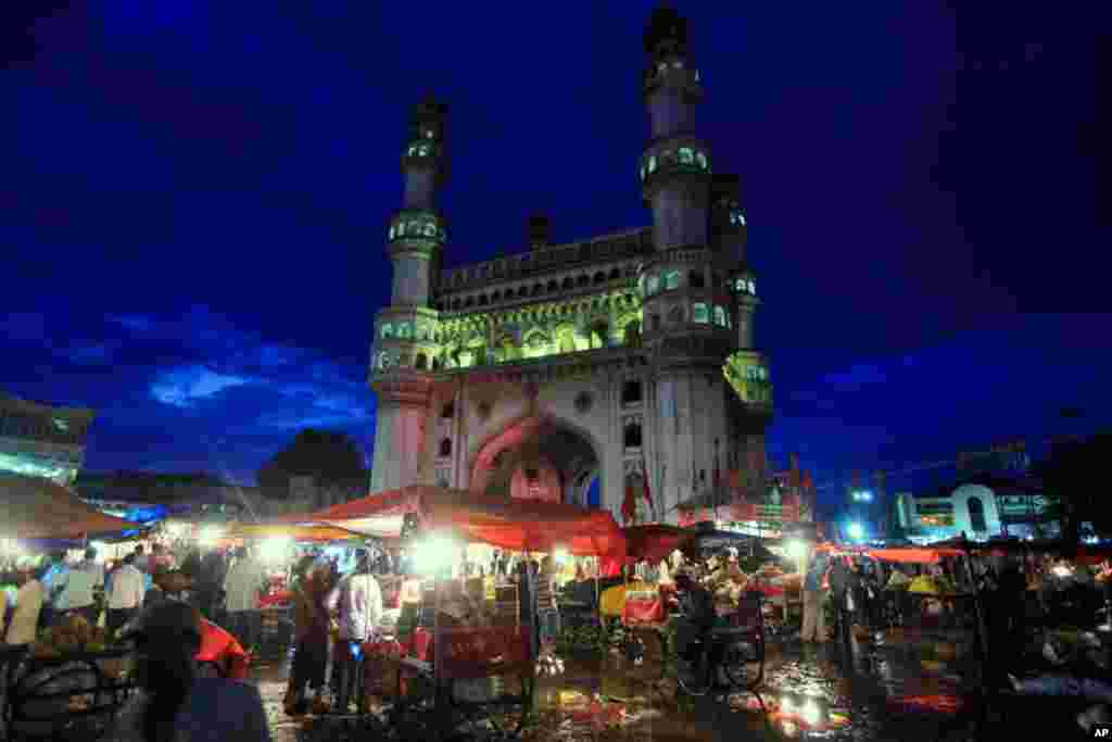 August 30: Muslim vendors sell delicacies from their push carts on the last day of Ramadan, in Hyderabad, India. Eid al-Fitr, marking the end of Ramadan will be celebrated Wednesday in India.(AP Photo/Mahesh Kumar A.)