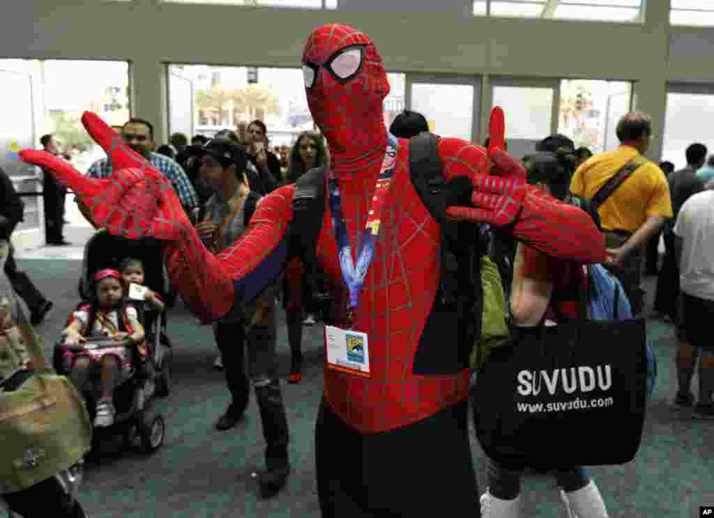 Taylor Roszkos, dressed as Spider Man, comes through the doors on first day of Comic-Con convention held at the San Diego Convention Center, July 12, 2012, in San Diego.