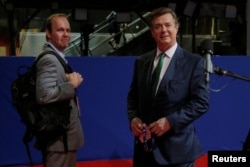 FILE - Paul Manafort, right, campaign manager to Republican Presidential Candidate Donald Trump, and his assistant Rick Gates stand on the floor of the Republican National Convention in Cleveland, July 17, 2016.