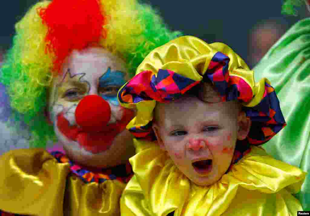 A family dressed as clowns participates in April Fools&#39; Day revelry at the city center in Skopje, Macedonia.
