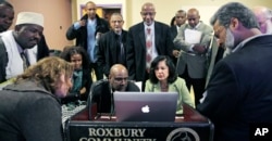 FILE - Muslim, Christian, minority and government leaders fix their eyes on a laptop screen showing a video as part of the program called Countering Violent Extremism, at Roxbury Community College in Boston, March 31, 2015.