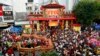 FILE - Residents watch a dragon dance ahead of the Cap Go Meh festival on Monday, which marks the end of Chinese New Year celebrations, on Malioboro street in Yogyakarta, Central Java, Indonesia, Feb. 7, 2009. 