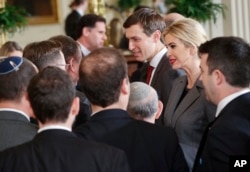FILE - U.S. presidential adviser Jared Kushner, center, and his wife, Ivanka Trump, daughter of President Donald Trump, greet members of the Israeli delegation after a joint news conference between the president and Israeli Prime Minister Benjamin Netanyahu in the East Room of the White House in Washington, Feb. 15, 2017.