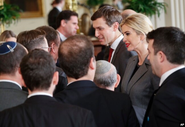 FILE - U.S. presidential adviser Jared Kushner, center, and his wife, Ivanka Trump, daughter of President Donald Trump, greet members of the Israeli delegation after a joint news conference between the president and Israeli Prime Minister Benjamin Netanyahu in the East Room of the White House in Washington, Feb. 15, 2017.