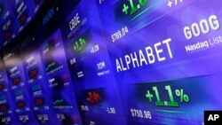 Electronic screens post prices of Alphabet stock, Feb. 1, 2016, at the Nasdaq MarketSite in New York. Alphabet, the parent company of Google, reports quarterly earnings Monday. 