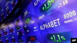 Electronic screens post prices of Alphabet stock, Monday, Feb. 1, 2016, at the Nasdaq MarketSite in New York. Alphabet, the parent company of Google, reports quarterly earnings Monday. 