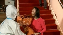 This screen grab made from video released on Sept. 25, 2021 by Chinese state broadcaster CCTV shows Huawei executive Meng Wanzhou receiving flowers after she arrived following her release, in Shenzhen.