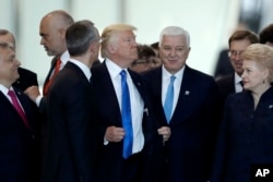 Montenegro Prime Minister Dusko Markovic, center right, after appearing to be pushed by Donald Trump, center, during a NATO summit of heads of state and government in Brussels, May 25, 2017.