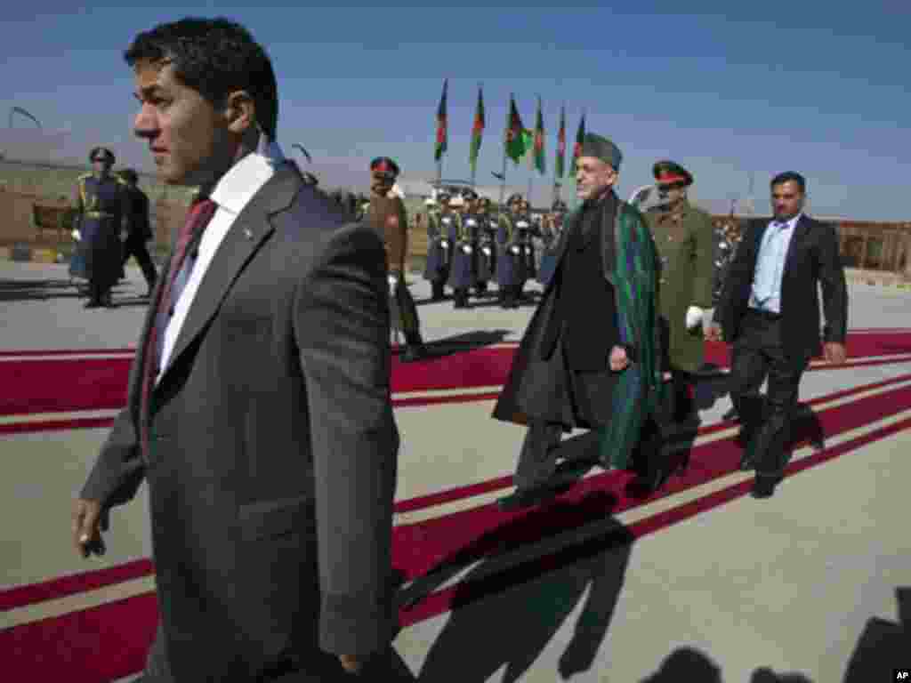 Afghan President Hamid Karzai inspects honor guards before inaugurating Afghanistan's parliament in Kabul January 26, 2011. Karzai will open parliament on Wednesday, ending a standoff with lawmakers, but setting the stage for a longer battle against an as