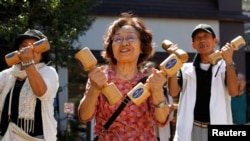 FILE - Elderly and middle-aged people exercise at a temple in Tokyo's Sugamo district, an area popular among the Japanese elderly, Japan, September 18, 2017. (REUTERS/Toru Hanai)