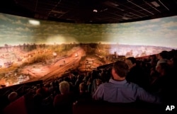 Visitors view the Atlanta Cyclorama, the colossal Civil War painting created about 130 years ago, June 30, 2015, in Atlanta.