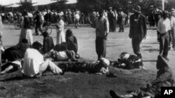 Wounded people lie in the street, 21 March 1960 in Sharpeville, near Vereeniging, where at least 180 black Africans, most of them women and children, were injured and 69 killed, when South African police opened fire on black protestors.