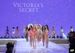Models including Behati Prinsloo, front left, and Lily Aldridge, front right, walk the runway during the Victoria's Secret Fashion Show at the Lexington Armory on Nov. 10, 2015, in New York.
