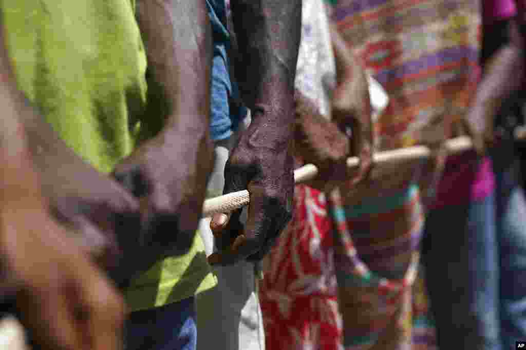 People line up for food aid in Camp Perrin, Haiti, six days after a 7.2 magnitude earthquake hit the area.