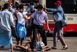 Massa pendukung militer mengancam dengan senjata tajam saat berhadapan dengan para pendukung antikudeta di Yangon, Myanmar, 25 Februari 2021. (Foto: dok)