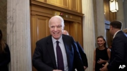 Sen. John McCain, R-Ariz., smiles as he arrives to vote as the Republican-run Senate rejected a GOP proposal to scuttle President Barack Obama's health care law, July 26, 2017, in Washington.