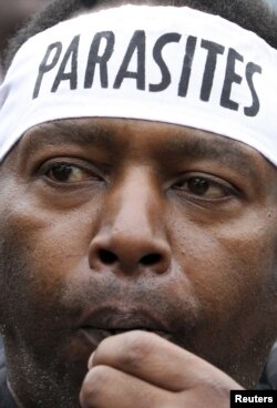 A July 8, 2010 photo shows a demonstrator blowing his whistle outside Parliament buildings in Kenya's capital Nairobi to protest the huge pay rises legislators have awarded themselves.