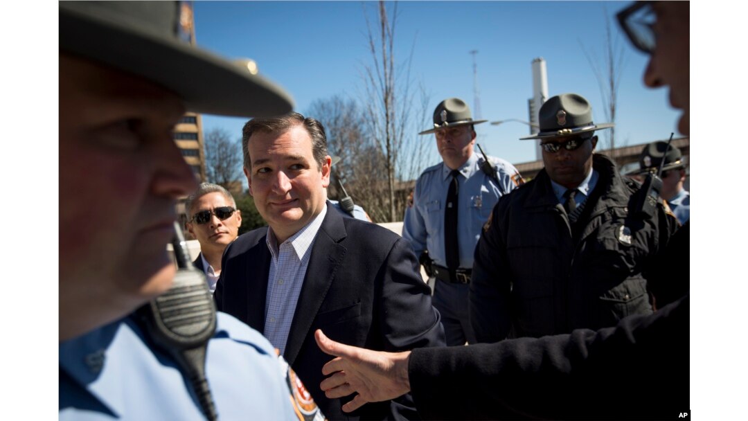 Republican presidential candidate Ted Cruz eyes a supporter reaching to shake his hand during a rally at Liberty Plaza in Atlanta, Feb. 27, 2016.
