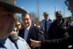 Republican presidential candidate Ted Cruz eyes a supporter reaching to shake his hand during a rally at Liberty Plaza in Atlanta, Feb. 27, 2016.