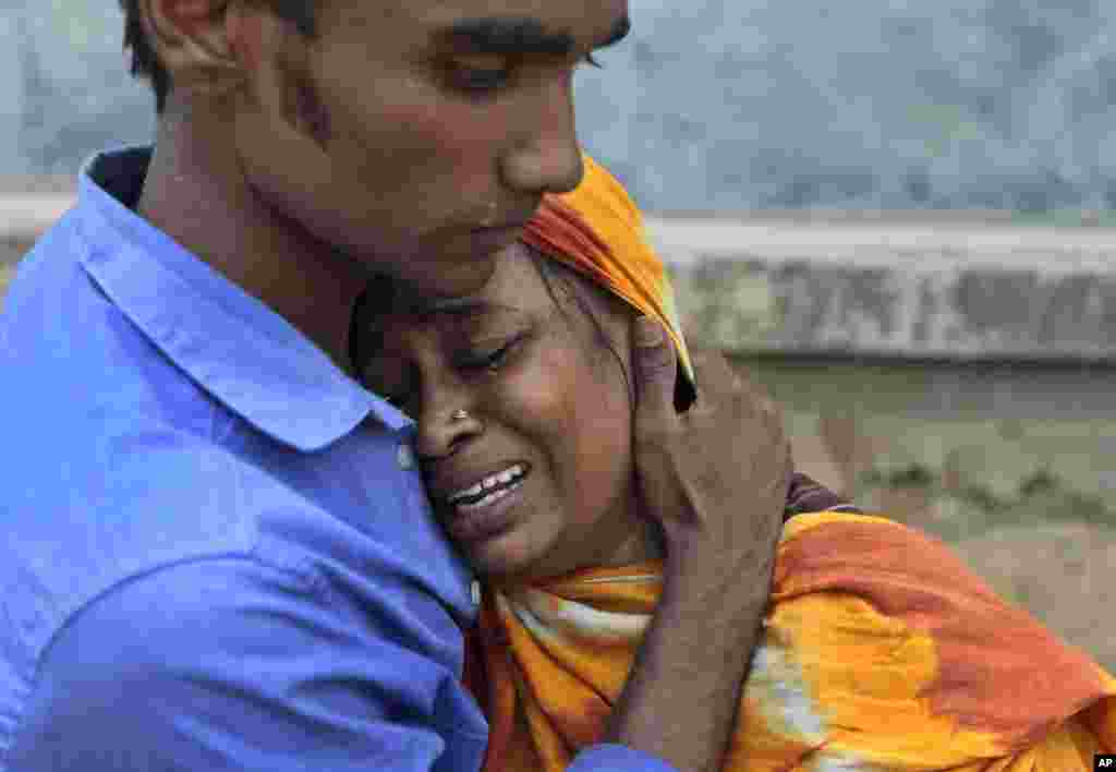 Relatives mourn a victim at the site after an eight-story building housing several garment factories collapsed in Savar, near Dhaka, Bangladesh, Apr. 24, 2013. 