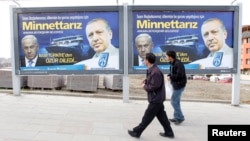 FILE - Pedestrians look at billboards with the pictures of Turkey's then prime minister, now President Recep Tayyip Erdogan (R) and his Israeli Prime Minister Benjamin Netanyahu, in Ankara, Turkey, March 25, 2013. The billboard was posted after Israel apo