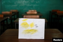 A drawing made during a lesson at a school shows what a student ate during the course of a day in Caracas, Venezuela, July 14, 2016. The student wrote, "Today I ate nothing for breakfast and had pasta with Mortadella for lunch. I'm hungry."