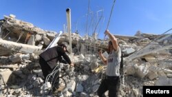 People look for survivors in the ruins of a destroyed Medecins Sans Frontieres (MSF) supported hospital hit by missiles in Marat Numan, Idlib province, Syria, February 16, 2016. 