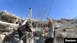 People look for survivors in the ruins of a destroyed Medecins Sans Frontieres (MSF) supported hospital hit by missiles in Marat Numan, Idlib province, Syria, February 16, 2016. 