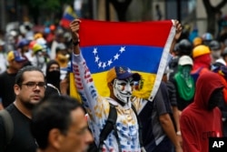 Demonstrators march against the government during protests in Caracas, Venezuela, Thursday, June 29, 2017. Demonstrators are taking to the streets after three months of continued protests against the government of President Nicolas Maduro.
