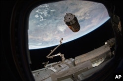 FILE - A photo provided by NASA TV shows a cargo ship as it arrives at the International Space Station, Dec. 13, 2016.