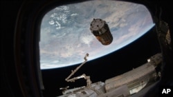 FILE - A photo provided by NASA TV shows a cargo ship as it arrives at the International Space Station, Dec. 13, 2016.