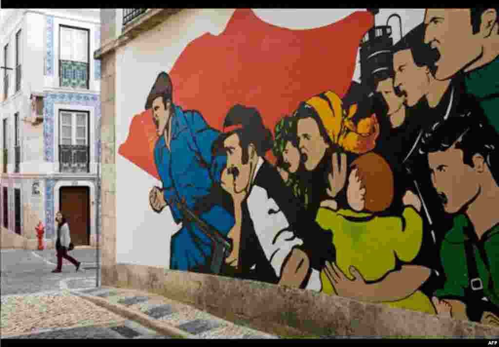 A young woman walks past a post-1974-revolution style mural Thursday, Nov. 25 2010, in Lisbon. As the government struggles to cope with the current international financial crisis, discontent with its austerity measures is on the rise among the Portuguese.