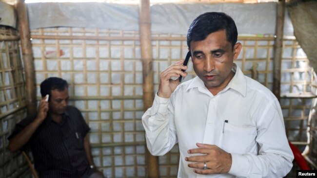 FILE - Mohib Ullah, a Rohingya Muslim leader from the Arakan Rohingya Society for Peace and Human Rights, speaks on a phone at his residence in Kutupalong refugee camp in Ukhiya, Cox’s Bazar, Bangladesh, April 21, 2018.