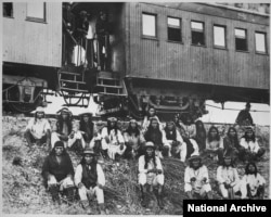Geronimo (front row, third from right) and his Chiricahua followers as prisoners of war en route to Florida, 1886.